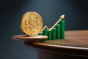 Golden dollar coin on table with green stock chart behind.