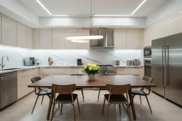 Renovated kitchen with marble countertop and stainless steel appliances.
